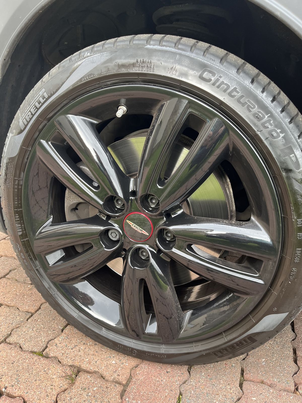 A gloss-black multi-spoke alloy fitted with a new tyre