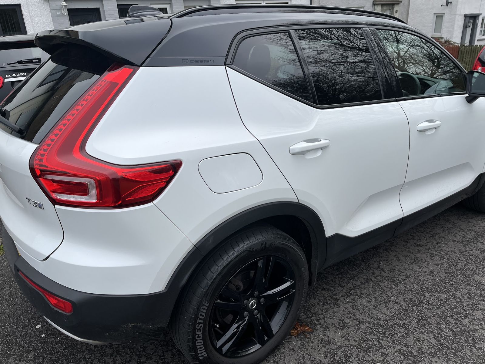 The rear of the white Volvo showing its black wheels