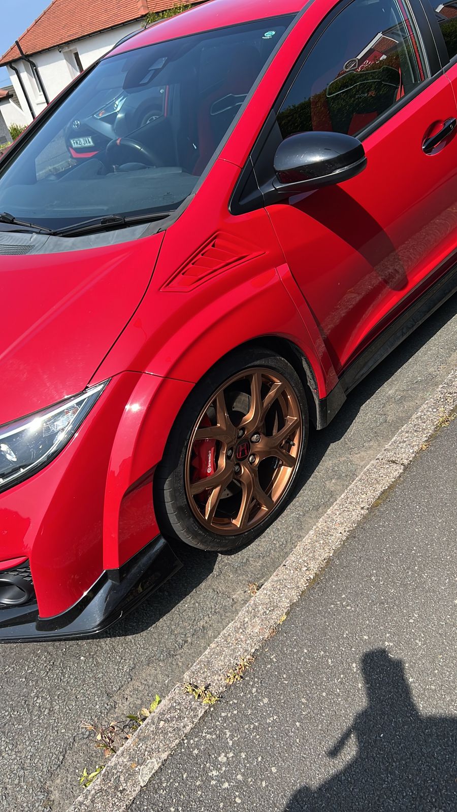 A red Honda Civic Type R on refurbished copper-bronze wheels